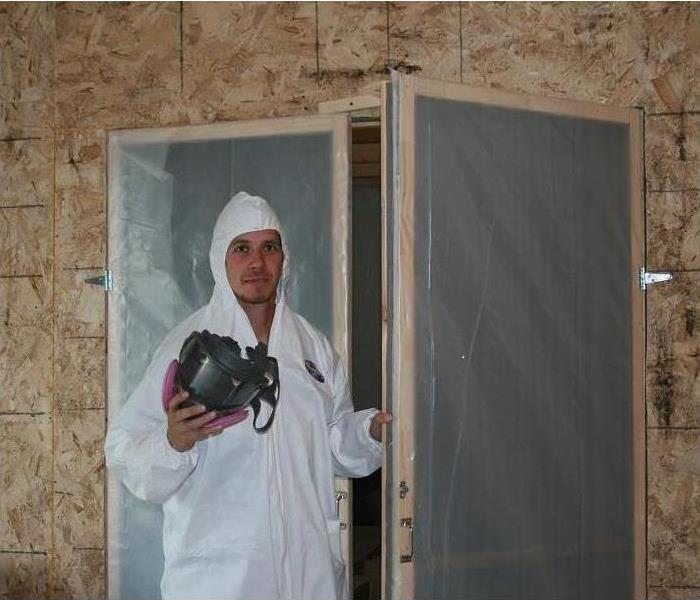 Technician wearing protective gear while doing mold containment